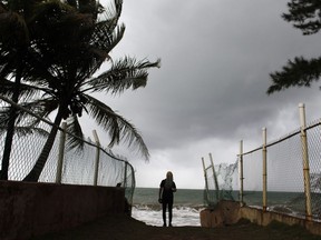 A woman looks at heavy surf as Hurricane Irma approaches Puerto Rico in Luquillo, on September 6, 2017. Irma is expected to reach the Virgin Islands and Puerto Rico by nightfall on September 6.