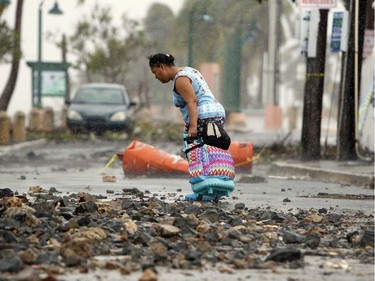PUERTORICO-WEATHER-HURRICANE-STORM

A woman pulls a travel case on a rock scattered road in the aftermath of Hurricane Irma in Fajardo, Puerto Rico, on September 7, 2017. One of the most powerful Atlantic storms on record, the rare Category 5 hurricane churned westward off the northern coast of Puerto Rico early Thursday on a potential collision course with south Florida, where at-risk areas were evacuated. / AFP PHOTO / Ricardo ARDUENGORICARDO ARDUENGO/AFP/Getty Images
RICARDO ARDUENGO, AFP/Getty Images