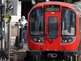 Police forensics officers work alongside an underground 'Tube' train at a platform at Parsons Green station in west London Friday, following an incident on an underground car at the station. British police are treating the incident as an act of terrorism.
