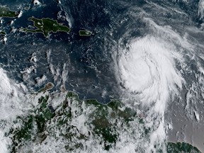 This satellite image obtained from the National Oceanic and Atmospheric Administration (NOAA) shows Hurricane Maria at 1215 UTC on September 18, 2017
