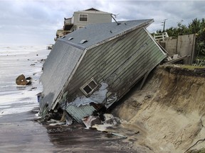 A house slides into the Atlantic Ocean in the aftermath of Hurricane Irma in Ponte Vedra Beach, Fla., Monday, Sept. 11, 2017.