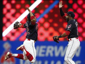 Cleveland Indians' Francisco Lindor, left, and Austin Jackson celebrate a 2-0 victory over the Detroit Tigers in a baseball game, Tuesday, Sept. 12, 2017, in Cleveland.