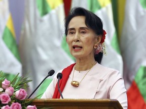 FILE - In this Friday, Aug. 11, 2017, file photo, Myanmar's State Counsellor Aung San Suu Kyi delivers an opening speech during the Forum on Myanmar Democratic Transition in Naypyitaw, Myanmar. Suu Kyi has canceled plans to attend the U.N. General Assembly, with her country drawing international criticism for violence that has driven at least 370,000 ethnic Rohingya Muslims from the country in less than three weeks. (AP Photo/Aung Shine Oo, File)