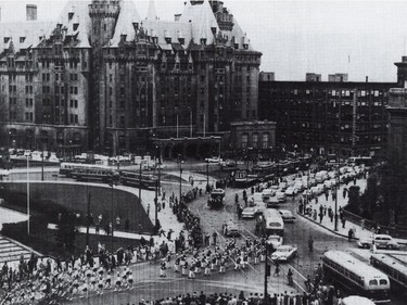 With the Chateau Laurier Hotel as a backdrop, about 25,000 people turned out to watch a parade of 17 transit vehicles, ranging from an 1870 horse drawn cart to new diesel buses, to mark the demise of the streetcar in Ottawa on May 4, 1959.