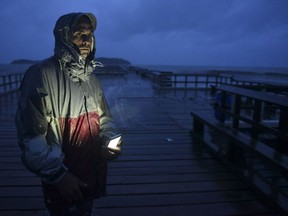 David Cruz Marrero watches the waves at Punta Santiago pier hours before the imminent impact of Maria, a Category 5 hurricane that threatens to hit the eastern region of the island with sustained winds of 165 miles per hour, in Humacao, Puerto Rico, Tuesday, September 19, 2017. (AP Photo/Carlos Giusti)