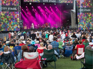 Fans watch from the comfort of their lawn chairs as Son Little performs on the City Stage on Friday. Wayne Cuddington/ Postmedia