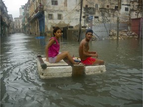 A couple floats down a flooded street in Havana atop a large piece of styrofoam, after the passing of Hurricane Irma in Cuba, Sunday, Sept. 10, 2017. The powerful storm ripped roofs off houses, collapsed buildings and flooded hundreds of miles of coastline after cutting a trail of destruction across the Caribbean.There were no immediate reports of deaths in Cuba, a country that prides itself on its disaster preparedness, but authorities were trying to restore power and clear roads. (AP Photo/Ramon Espinosa) ORG XMIT: XRE117
Ramon Espinosa, AP