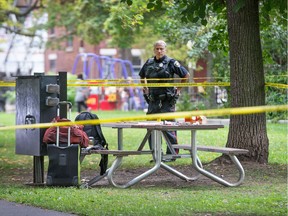 Police officer guards the scene in Dundonald Park at MacLaren Street and Lyon Street after police shut down an apparent makeshift meth cooking operation early Friday. The suspect was using a nearby city power supply that was easily accessed. Wayne Cuddington, Postmedia