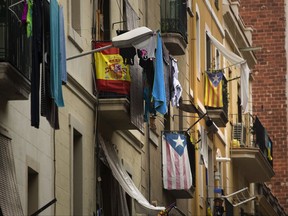 in this Wednesday, Sept. 6, 2017 photo, balconies decorated with Esteladas or pro independence flags and also a Spanish flag are seen in Barcelona, Spain.