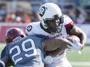 Redblacks tailback William Powell, right, breaks away from a tackle by Alouettes defender Jonathan Mincy during second-half action in Montreal on Sunday. THE CANADIAN PRESS/Graham Hughes