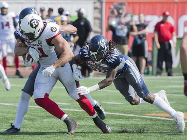 Ottawa Redblacks' fullback Patrick Lavoie (81) breaks through the Montreal Alouettes defense during first half CFL football action in Montreal, Sunday, September 17, 2017.