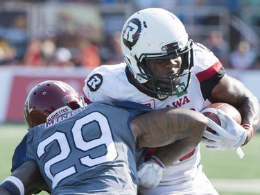 Ottawa Redblacks' William Powell, right, breaks away from a tackle by Montreal Alouettes' Jonathan Mincy (29) during second half CFL football action in Montreal, Sunday, September 17, 2017.