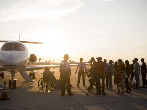 People arrive in West Palm Beach, Fla., from Puerto Rico on Tuesday, Sep. 26, 2017. The Eagles Wings Foundation led a mission that transported elderly nursing home patients and some family members to safety after Hurricane Maria struck Puerto Rico. With power out across nearly the entire island, families were anxious in particular to get out elderly and other vulnerable relatives amid concerns about access to food and fresh water. (Calla Kessler/Palm Beach Post via AP)