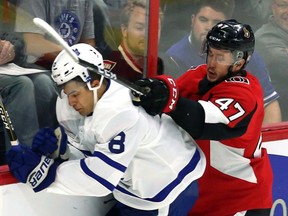 Senators forward Francis Perron (47) checks Maple Leafs defenceman Connor Carrick during the first period of Monday's pre-season game. THE CANADIAN PRESS/Fred Chartrand