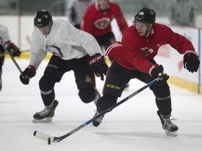 Senators defence prospect Thomas Chabot chases Pius Suter during a scrimmage on the second day of training camp Friday. THE CANADIAN PRESS/Adrian Wyld