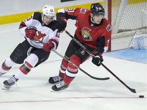 Ottawa Senators Logan Brown, right, is checked by New Jersey Devils Nico Hischier, of Switzerland, during third period NHL preseason hockey action in Summerside, P.E.I., on Monday, Sept. 25, 2017. New Jersey won 8-1.