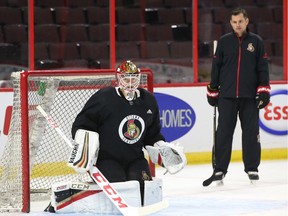 Mike Condon of the Ottawa Senators works with the goalie coach Pierre Groulx during morning skate at Canadian Tire Centre on Tuesday.