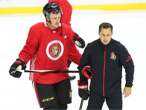 Dion Phaneuf chats with Senators head coach during a practice on Friday in Ottawa. Phaneuf spends time in P.E.I. with his wife, Elisha Cuthbert, during the offseason. Jean Levac/Postmedia