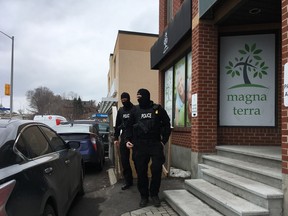 Police carry out cannabis products during a raid on the Magna Terra dispensary on Carling Avenue on March 21, 2017.