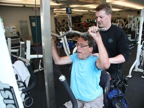 A friend is trying to assist double amputee John Woodhouse, shown training with Ryan Amitage, obtain a new wheelchair.