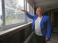 Gatineau Coun. Sylvie Goneau shows waterline on window that marks how high flood waters were in her home. She has been told she must demolish her house because it is within a flood zone.