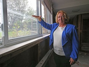 Sylvie Goneau shows how high the water rose in the basement of her former home in Gatineau.