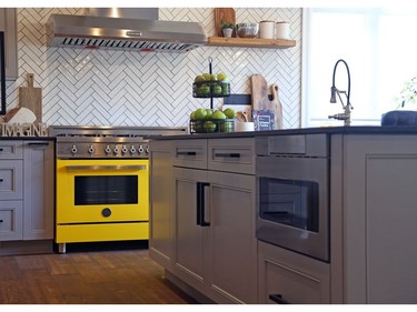 The stove gives a pop of yellow in the kitchen of the Minto Home for the CHEO Dream of a Lifetime Lottery in Ottawa.
