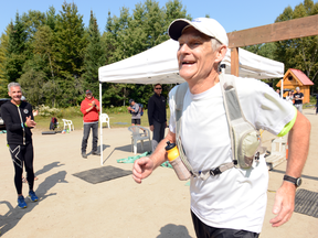 People applaud as Jack Judge crosses the finish line at the Haliburton Forest 100 on Saturday.
