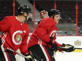 Thomas Chabot, left, and Dion Phaneuf of the Senators during Friday morning's on-ice session at Canadian Tire Centre. Jean Levac/Postmedia
