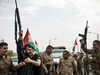 Kurdish soldiers fire their guns in the air to celebrate the independence referendum, outside a voting station on Sept. 25, 2017 in Kirkuk, Iraq.