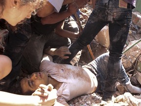 A man is rescued from a collapsed building in the Condesa neighborhood of Mexico City after an earthquake in Mexico, Tuesday, Sept. 19, 2017.