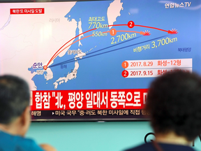 People watch a screen showing a graphic of a North Korean missile launch, at a railway station in Seoul on Sept. 15, 2017.