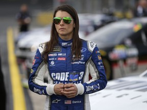 In this May 25 file photo, Danica Patrick stands by her car before qualifying for a NASCAR Cup Series auto race at Charlotte Motor Speedway in Concord, N.C.