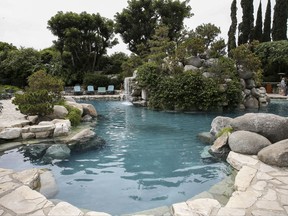 FILE - This May 11, 2016 file photo shows the pool area at the Playboy Mansion in Los Angeles. Hugh Hefner bought the Holmby Hills property in 1971 and turned it into the epicenter of his growing magazine and lifestyle enterprise. A neighbor bought the property for $100 million in 2016 with the stipulation that Hefner could live the rest of his years there. He died Wednesday at 91. (Photo by John Salangsang/Invision/AP, File)