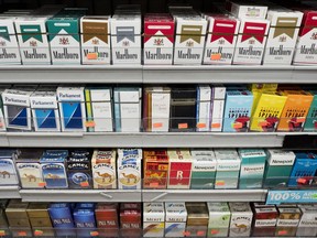 Cigarettes are displayed on a shelf, Monday, Aug. 28, 2017, in New York. Mayor Bill de Blasio is expected to sign legislation raising the legal minimum price for a pack of cigarettes to $13. The hike from $10.50 further cements the city's claim on having among the most expensive cigarettes in the country. (AP Photo/Mark Lennihan)