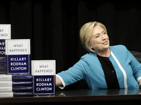 Hillary Rodham Clinton prepares to sign copies of her book "What Happened" at a book store in New York, Tuesday, Sept. 12, 2017. (AP Photo/Seth Wenig)