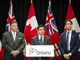 Ontario Attorney General Yasir Naqvi, centre, Minister of Finance Charles Sousa, left, and Minister of Health and Long-Term Care Eric Hoskins speak during a press conference where they detailed Ontario's solution for recreational marijuana sales, in Toronto on Friday, September 8, 2017. THE CANADIAN PRESS/Christopher Katsarov