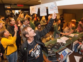 Peer-support volunteer Bob Jamison puts up a sign in the reception area for councillors at city hall. Overdose Prevention Ottawa protesters demanded to meet Councillor Mathieu Fleury but were prevented from going any further in the reception area for councillors during a rally protesting city threats to close down the overdose prevention site.