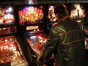 Mark McHale, co-owner of Ottawa's only pinball and perogie music venue, House of Targ, is photographed playing one of the classic pinball machines they have on Tuesday April 15, 2014.Darren Brown/Ottawa Sun/QMI Agency
Darren Brown, Darren Brown/Ottawa Sun/QMI Agency