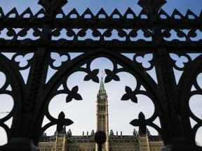 Files: Parliament Hill, Centre Block framed by ornate fence.