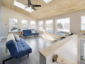 AFTER- This small home addition -approximately  $80,000- created a beautiful all-season room that the entire family could enjoy. Venture outdoors to the brand-new hot tub or relax inside and take in the view.