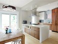 The new kitchen is modern white-and-wood Scandinavian-style space. With the load-bearing wall removed and the windows uncovered- it's a beautiful light-filled space.