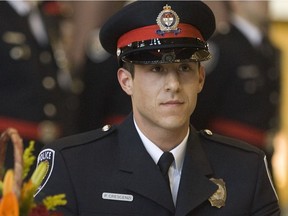 Constable Paolo Crescenzi signs the register during the Ottawa Police Service graduation ceremony for new officers in 2009. Chris Mikula/Postmedia