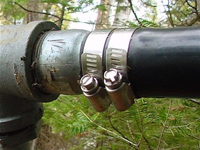 Two screw clamps tightened on a softened black polyethylene pipe is essential for a leak-proof connection. Black poly pipe like this is the most common kind used for cottage water intake lines.