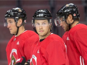 Ryan Dzingel, centre, stands with Kyle Turris, left, and Bobby Ryan at practice on Thursday, Sept. 21, 2017. Dzingel has been bothered by a groin injury, but said after the skate that he felt 'a lot better.'