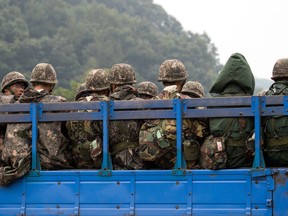 South Korean soldiers -- all men -- sit in an army truck during a military exercise near the border in Paju, South Korea, on Sept. 6, 2017