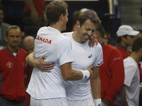 Canada's Vasek Pospisil, left, and Daniel Nestor celebrate Saturday's win against India during Davis Cup doubles tennis in Edmonton. THE CANADIAN PRESS/Jason Franson