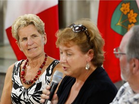 Premier Kathleen Wynne, left, talks about the provincial government's minimum wage plan at a community meeting in Peterborough in August.