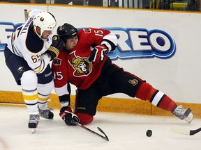 Senators forward Zack Smith (15) gets knocked off his skates by the Sabres' Travis Turnbull in the second period of the 2010 Kraft Hockeyville game at Dundas, Ont.
Craig Robertson/Postmedia