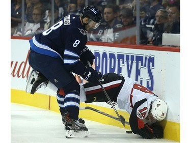 Winnipeg Jets defenceman Jacob Trouba shoves Ottawa Senators forward Ryan Dzingel into the boards.